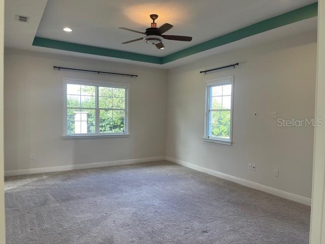 2600 Meadowedge Loop St. Cloud, FL 34772 - Photo 39 of 82 an empty room with windows and a ceiling fan
