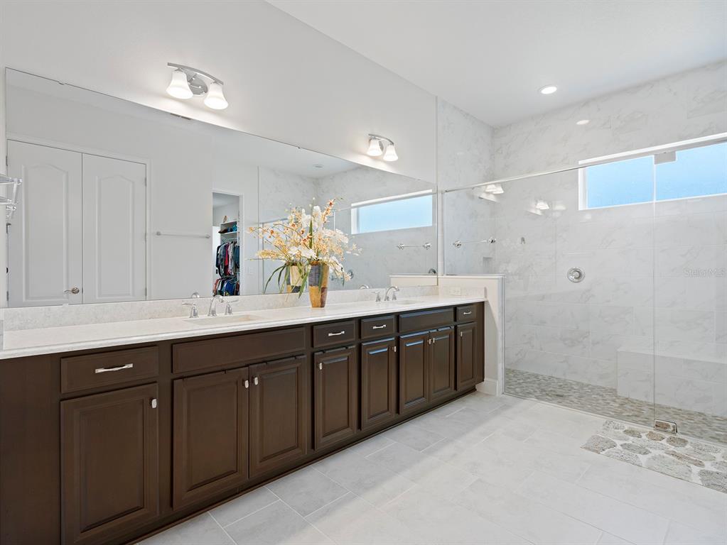 2600 Meadowedge Loop St. Cloud, FL 34772 - Photo 41 of 82 a spacious bathroom with a double vanity sink mirror and double