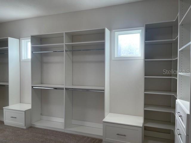 2600 Meadowedge Loop St. Cloud, FL 34772 - Photo 45 of 82 a view of walk in closet with empty racks