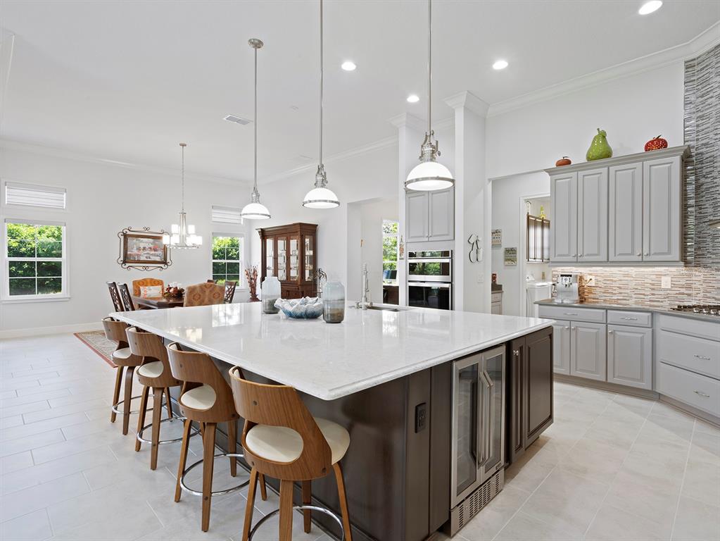 2600 Meadowedge Loop St. Cloud, FL 34772 - Photo 5 of 82 a large kitchen with kitchen island a table and chairs in it