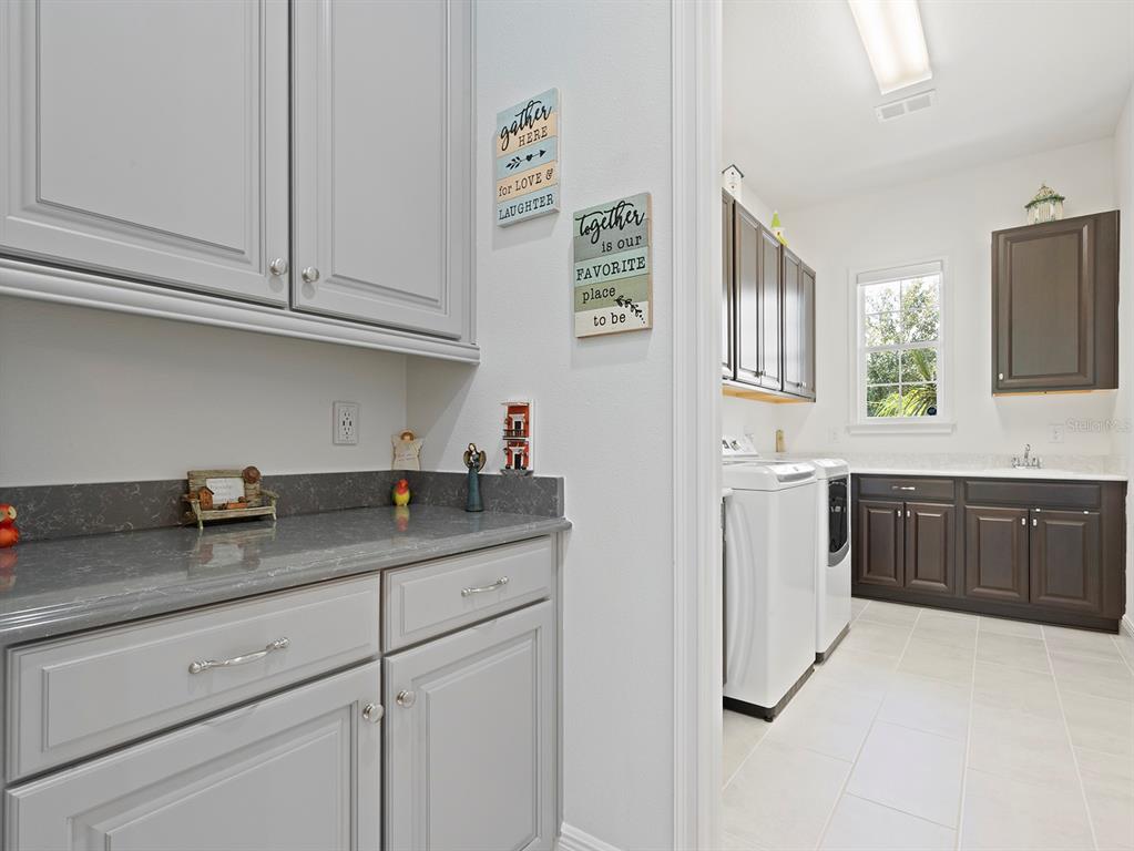 2600 Meadowedge Loop St. Cloud, FL 34772 - Photo 54 of 82 a kitchen with stainless steel appliances granite countertop a sink stove and cabinets