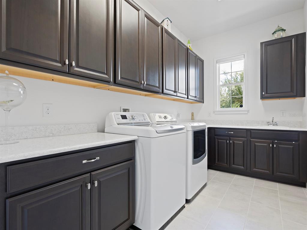 2600 Meadowedge Loop St. Cloud, FL 34772 - Photo 55 of 82 a kitchen with stainless steel appliances granite countertop a sink stove and microwave