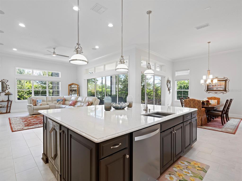 2600 Meadowedge Loop St. Cloud, FL 34772 - Photo 6 of 82 a kitchen with center island and large windows