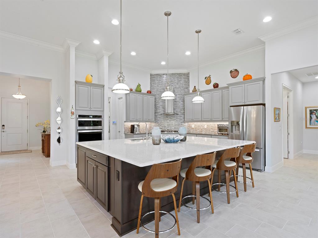 2600 Meadowedge Loop St. Cloud, FL 34772 - Photo 7 of 82 a large kitchen with a table and chairs