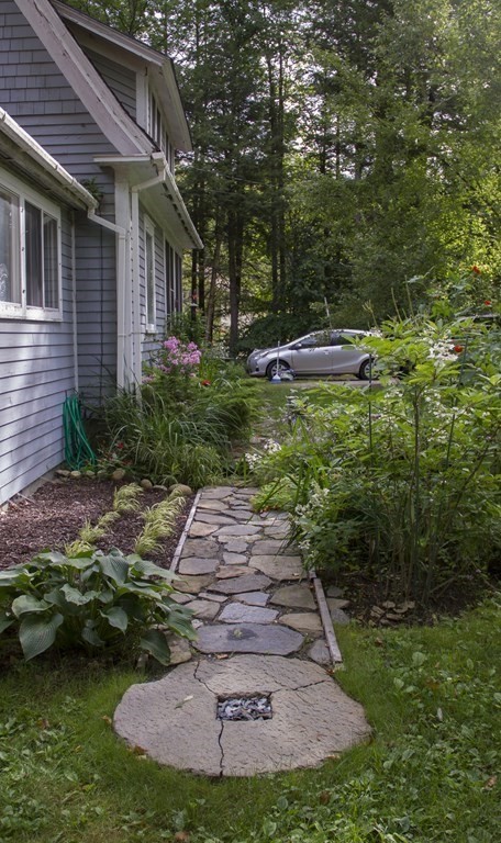 664 Main Road Chesterfield, MA 01012 - Photo 19 of 22 a front view of a house with a yard