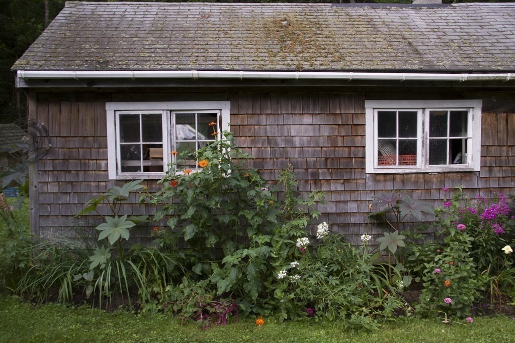 664 Main Road Chesterfield, MA 01012 - Photo 21 of 22 a view of a stone house with a small yard