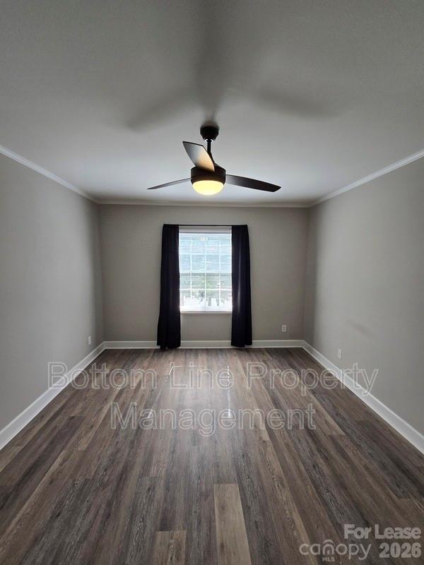 5949 Quail Hollow Road, Unit D Charlotte, NC 28210 - Photo 25 of 34 a view of an empty room with a window and wooden floor