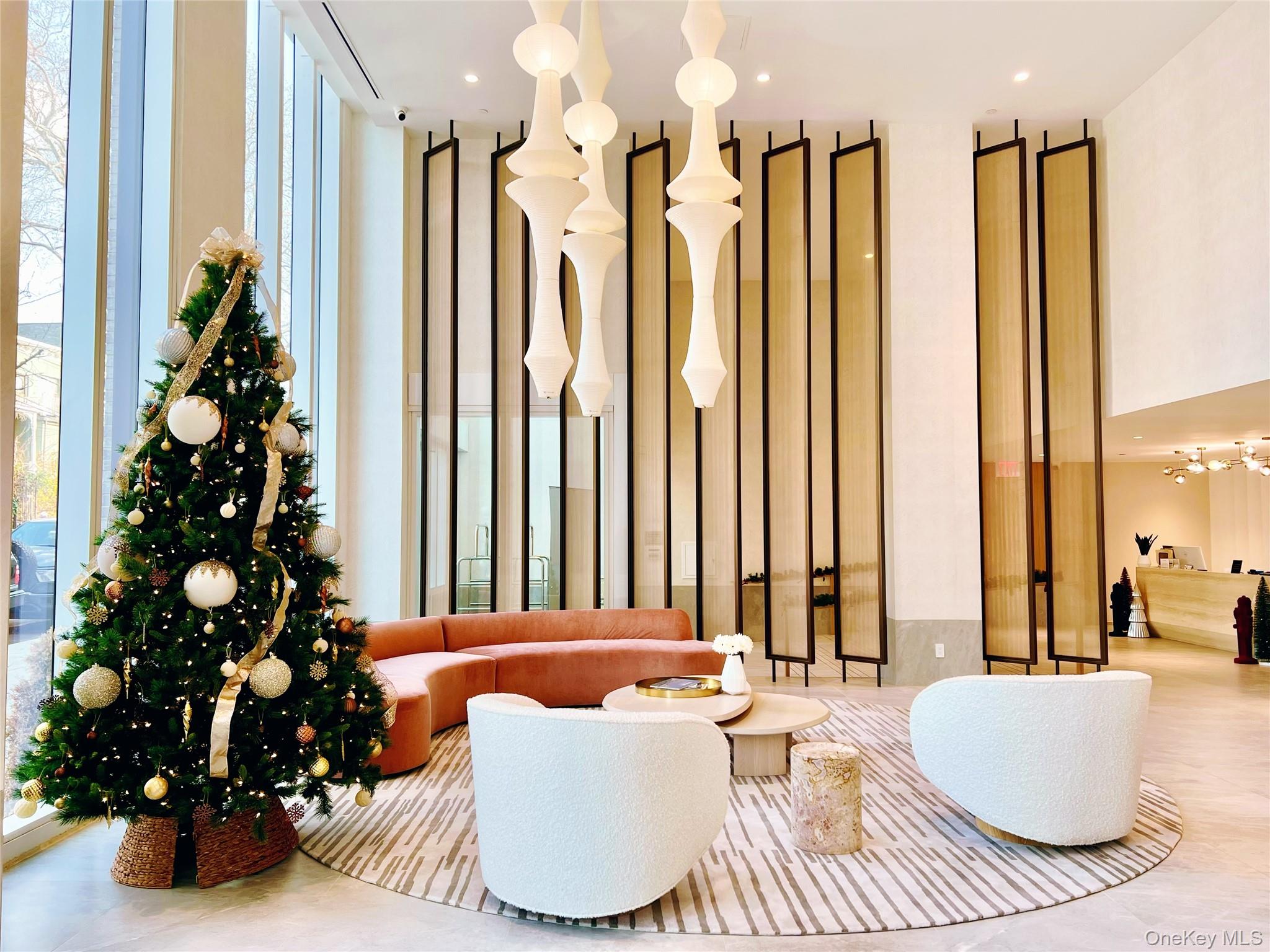 30-55 Vernon Boulevard, Unit 6G Queens, NY 11102 - Photo 2 of 16 a living room with furniture and a large window