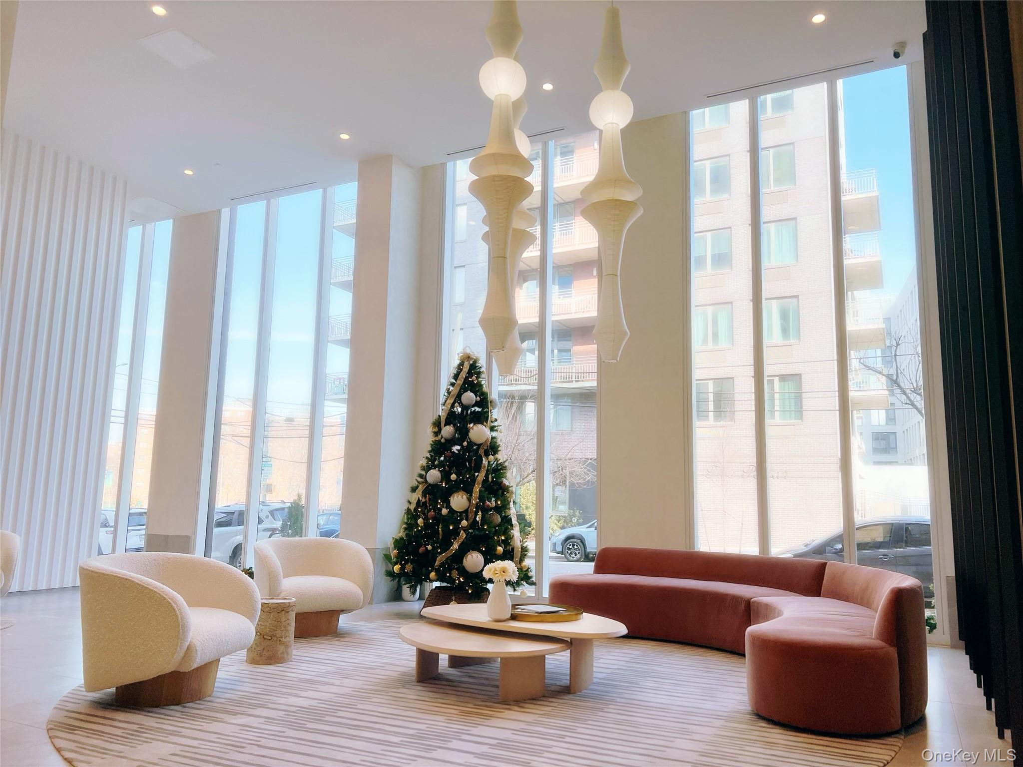 30-55 Vernon Boulevard, Unit 6G Queens, NY 11102 - Photo 3 of 16 a living room with furniture and a large window