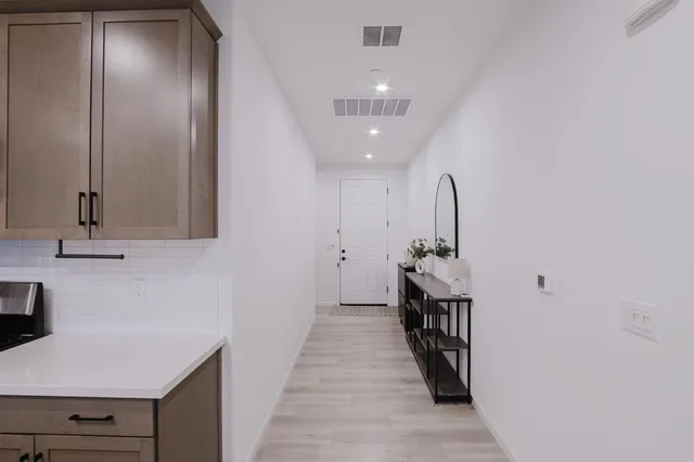 a hallway with front door wooden floor and front door