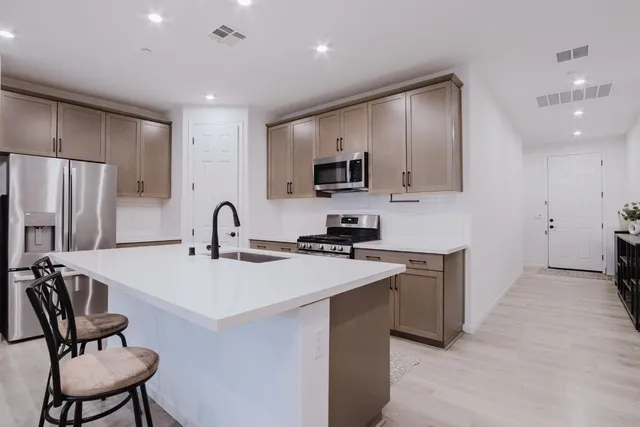 a kitchen with a sink stainless steel appliances and cabinets