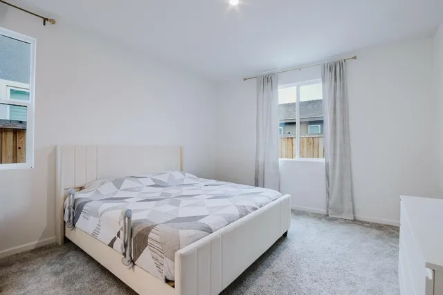 a bed sitting in a bedroom next to a window and closet