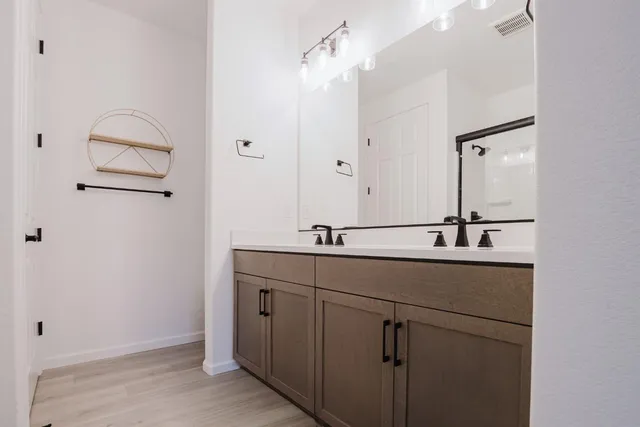 a bathroom with a double vanity sink and mirror
