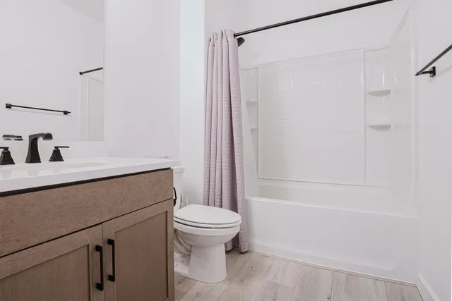 a bathroom with a shower a toilet and a sink