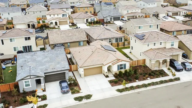 an aerial view of residential houses with street