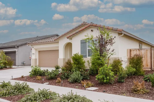 a front view of a house with garden