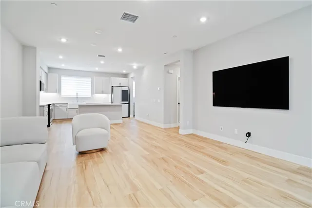 a view of a living room a dining room with furniture and flat screen tv