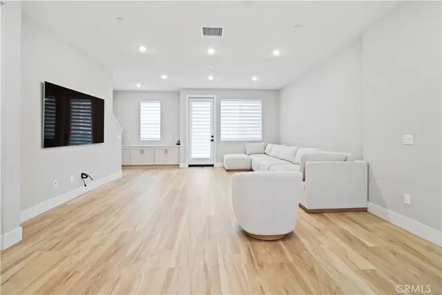 a living room with a flat screen tv a couch and a window