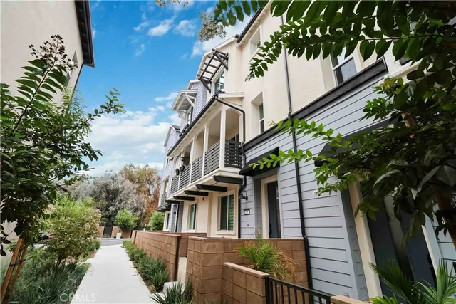 a view of a house with brick walls and a flower garden