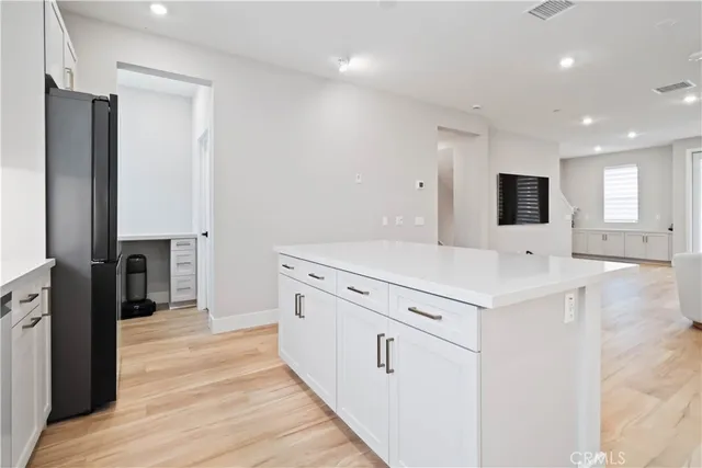 a kitchen with kitchen island a sink stainless steel appliances and cabinets