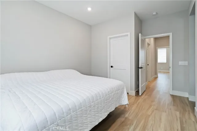 a bedroom with a flat screen tv and a bed