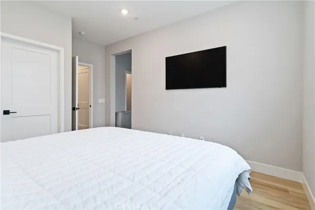 a bedroom with a bed and a flat screen tv