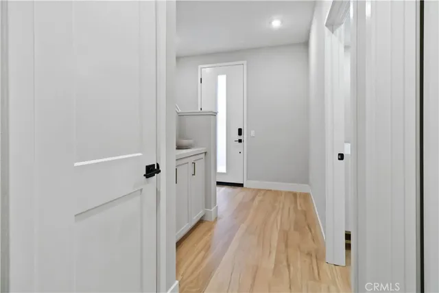 a view of a hallway with wooden floor and staircase