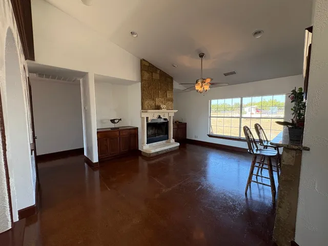 a dining room with furniture and a floor to ceiling window