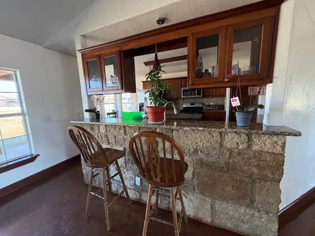 a living room with furniture a flat screen tv and a large window