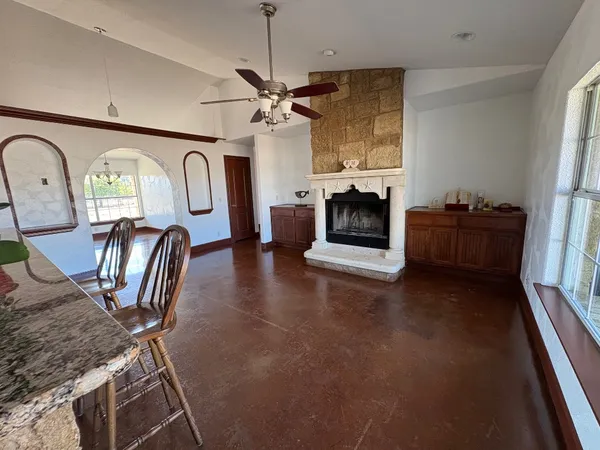 a room with two couches and wooden floor
