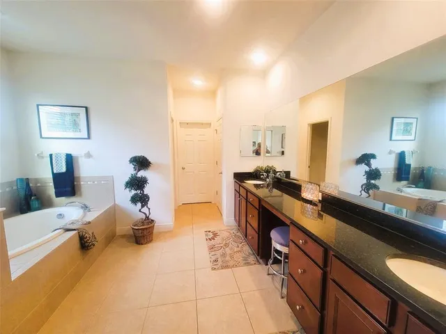 a large bedroom with a large bed and furniture