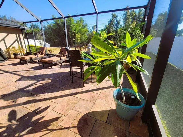a view of a porch with chairs and backyard