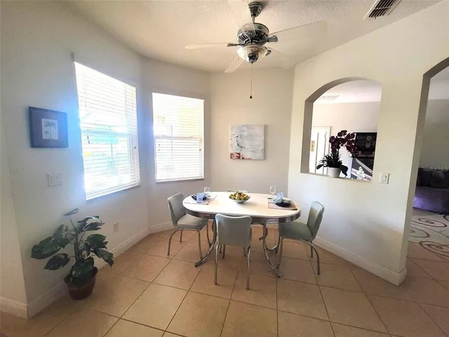 a view of a dining room with furniture and a chandelier