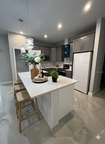 a kitchen with a refrigerator and a wooden cabinets