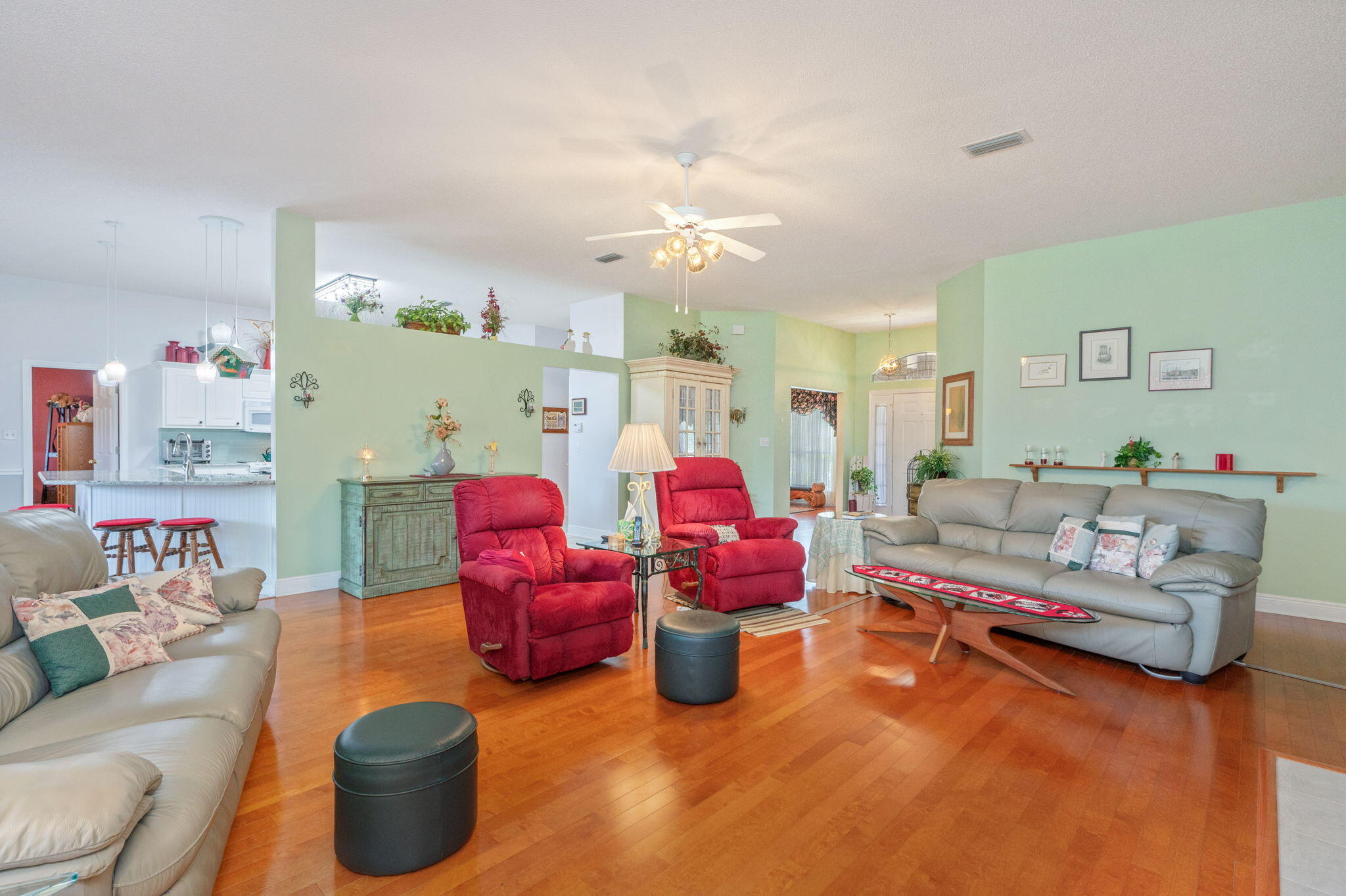 5863 Hunting Meadows Drive Crestview, FL 32536 - Photo 13 of 49 a living room with lots of furniture and a chandelier