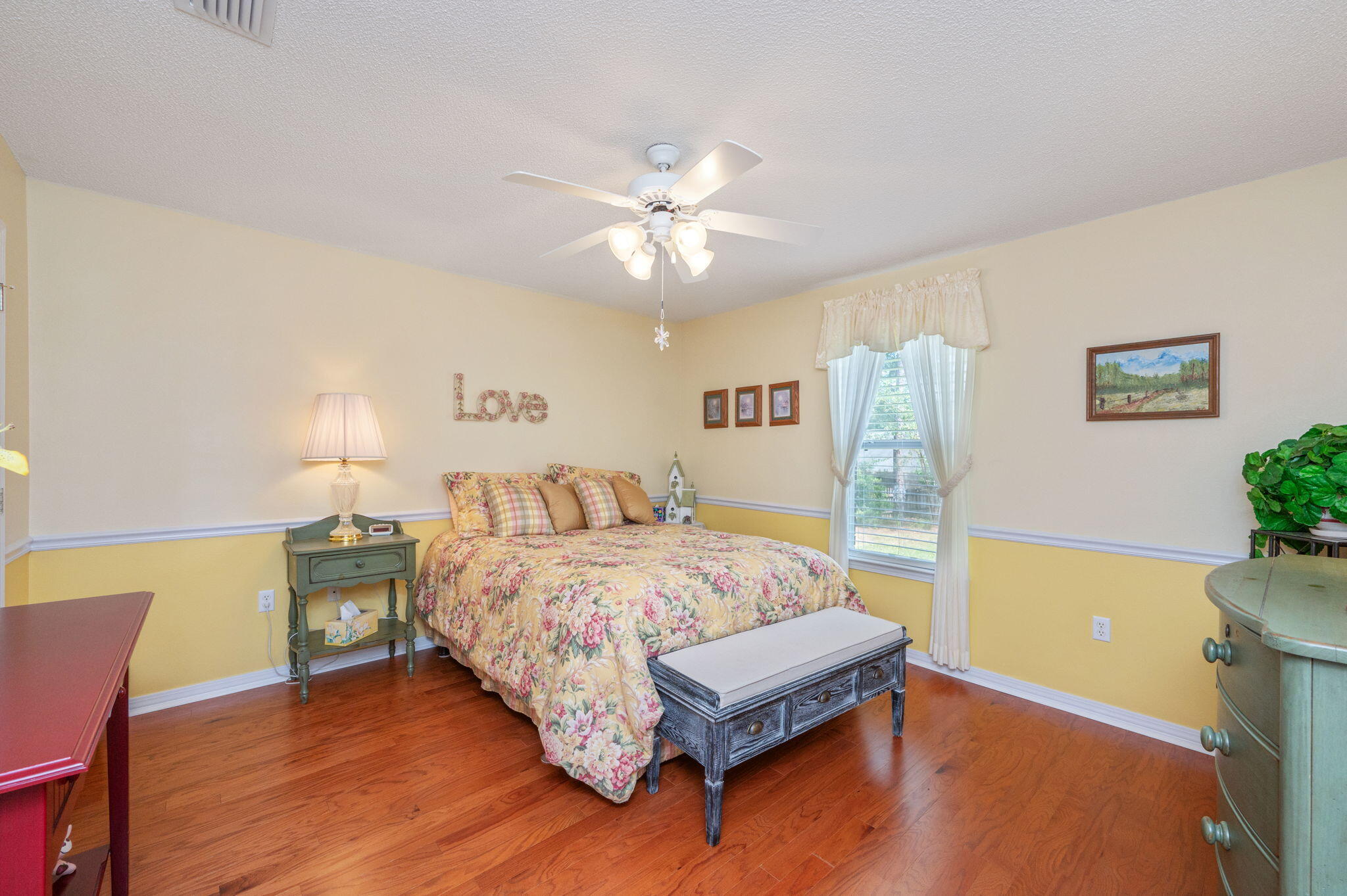 5863 Hunting Meadows Drive Crestview, FL 32536 - Photo 18 of 49 a bedroom with a bed and a table in it