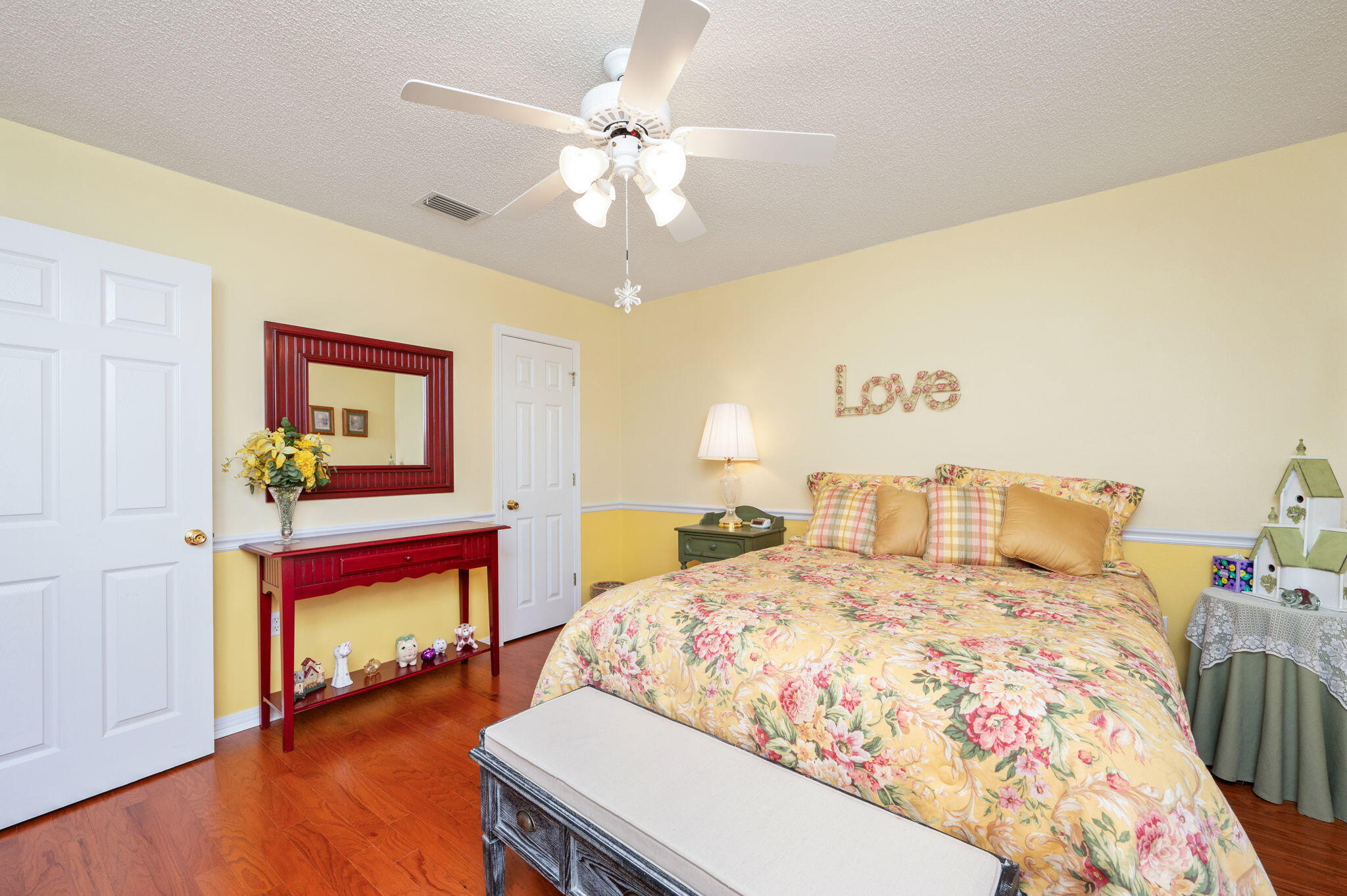 5863 Hunting Meadows Drive Crestview, FL 32536 - Photo 19 of 49 a bedroom with a bed and wooden floor