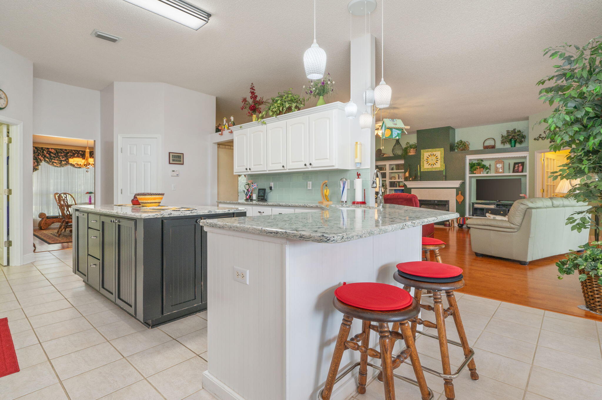 5863 Hunting Meadows Drive Crestview, FL 32536 - Photo 26 of 49 a kitchen with stainless steel appliances granite countertop a kitchen island and chairs in it