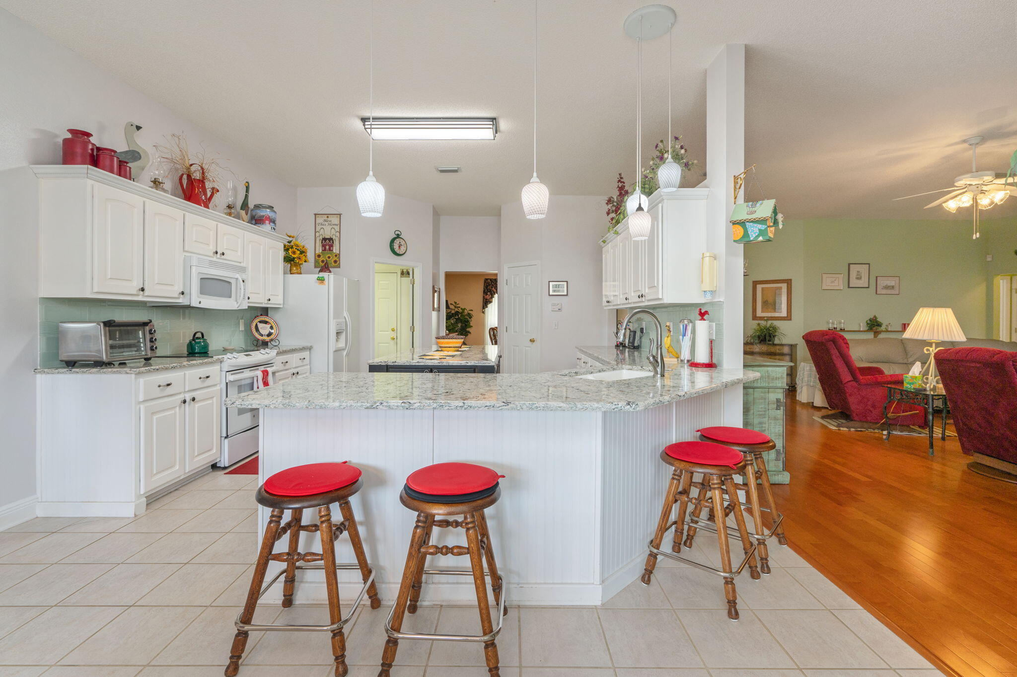 5863 Hunting Meadows Drive Crestview, FL 32536 - Photo 27 of 49 a kitchen with a dining table chairs sink and cabinets