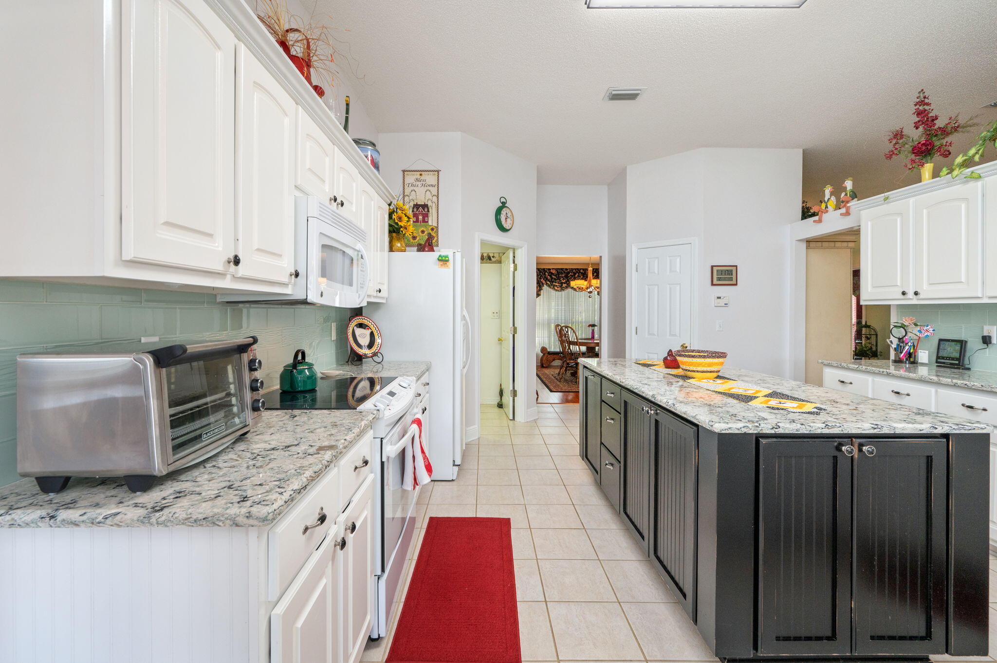 5863 Hunting Meadows Drive Crestview, FL 32536 - Photo 28 of 49 a kitchen with granite countertop a sink a counter top space stainless steel appliances and cabinets