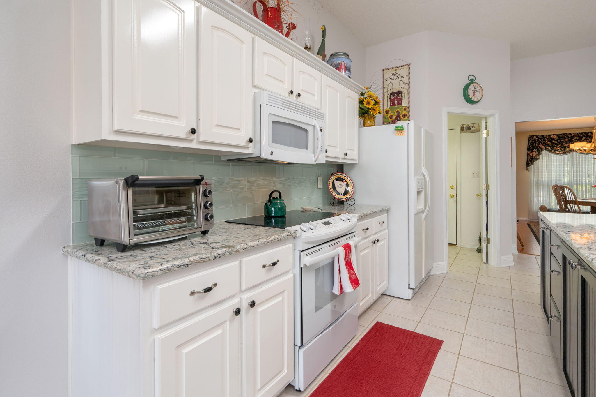 5863 Hunting Meadows Drive Crestview, FL 32536 - Photo 29 of 49 a kitchen with stainless steel appliances granite countertop a stove a sink and a microwave