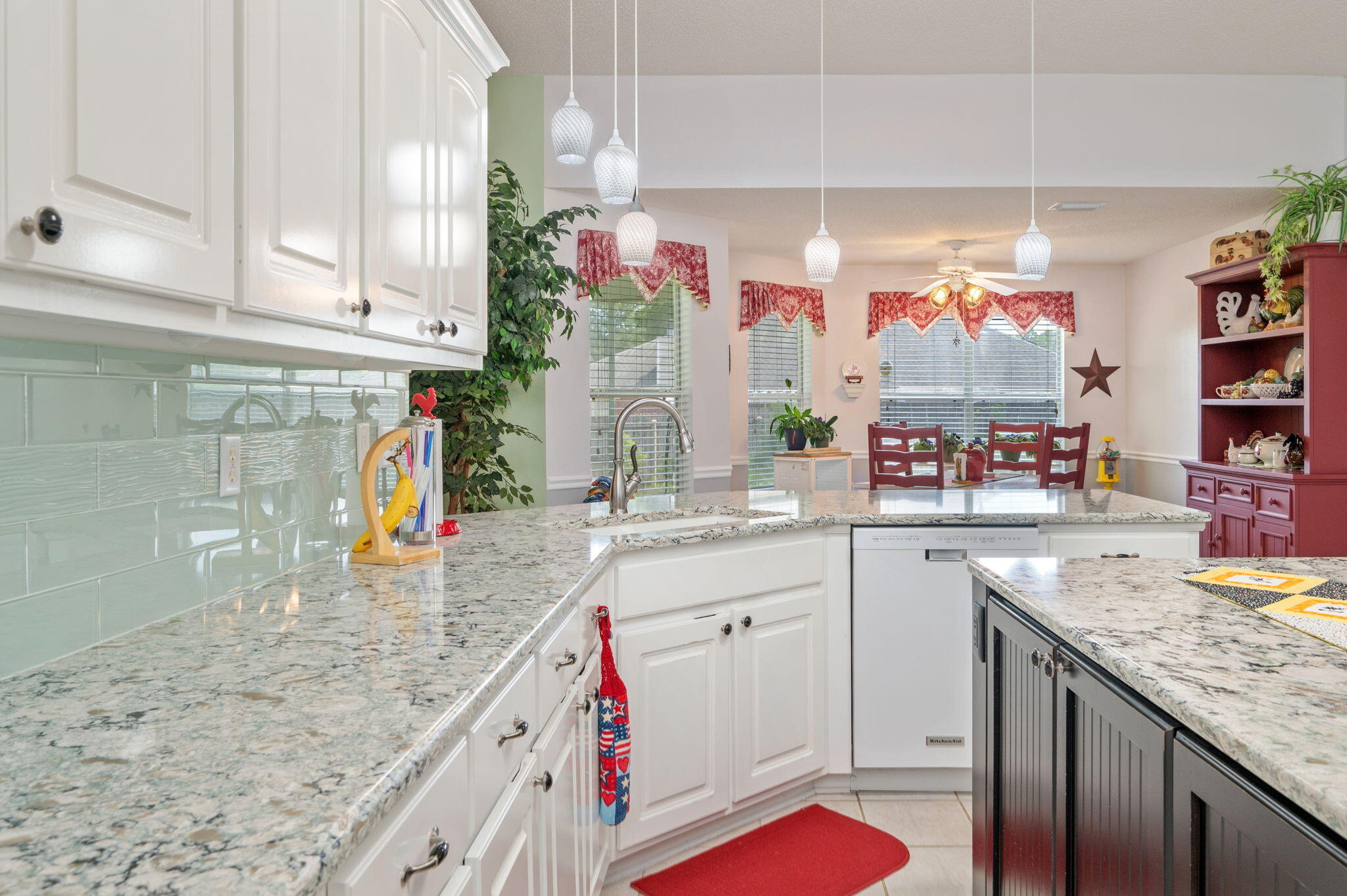 5863 Hunting Meadows Drive Crestview, FL 32536 - Photo 31 of 49 a kitchen with granite countertop a sink a stove and cabinets