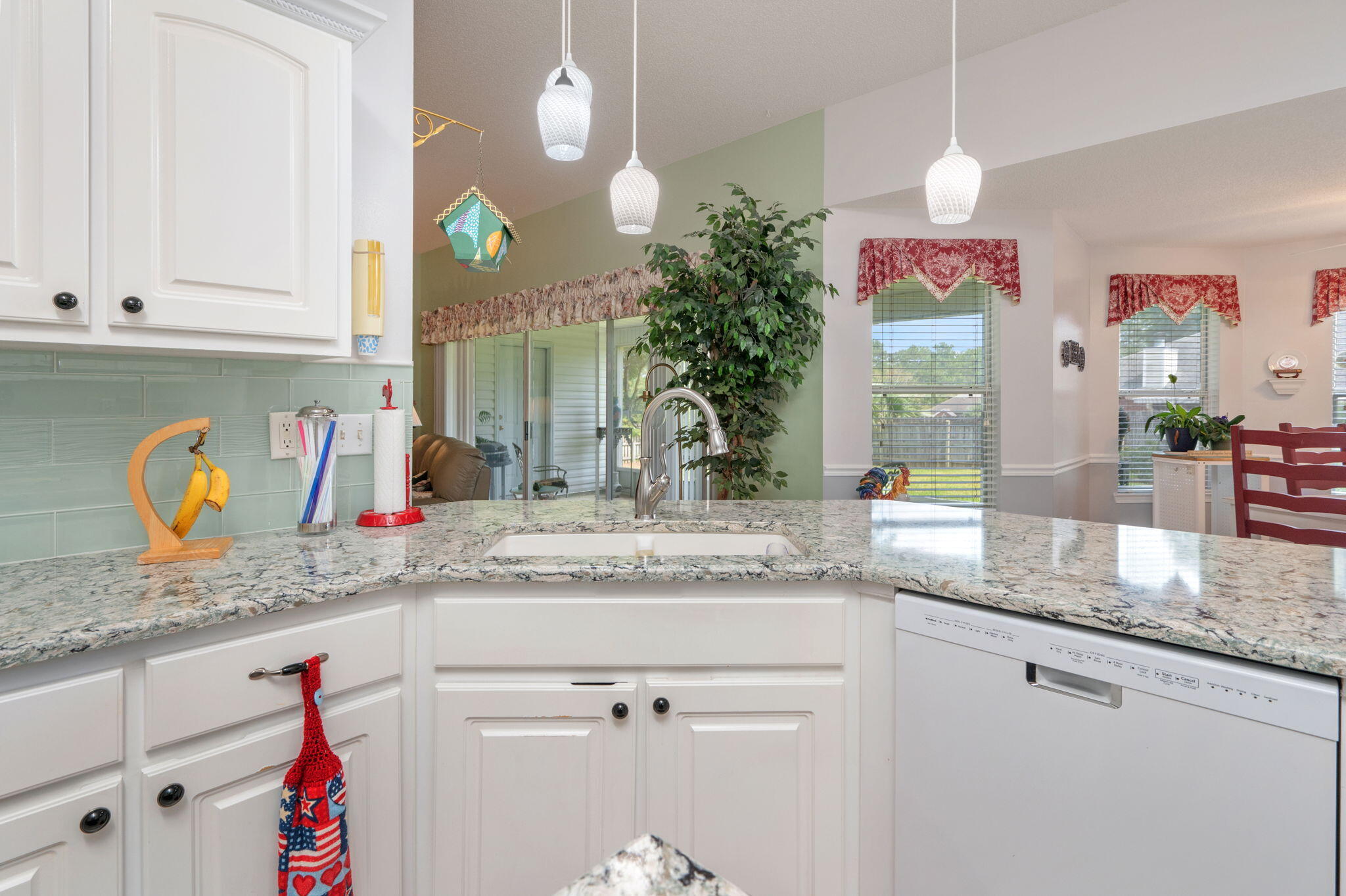5863 Hunting Meadows Drive Crestview, FL 32536 - Photo 32 of 49 a kitchen with granite countertop a sink and white cabinets