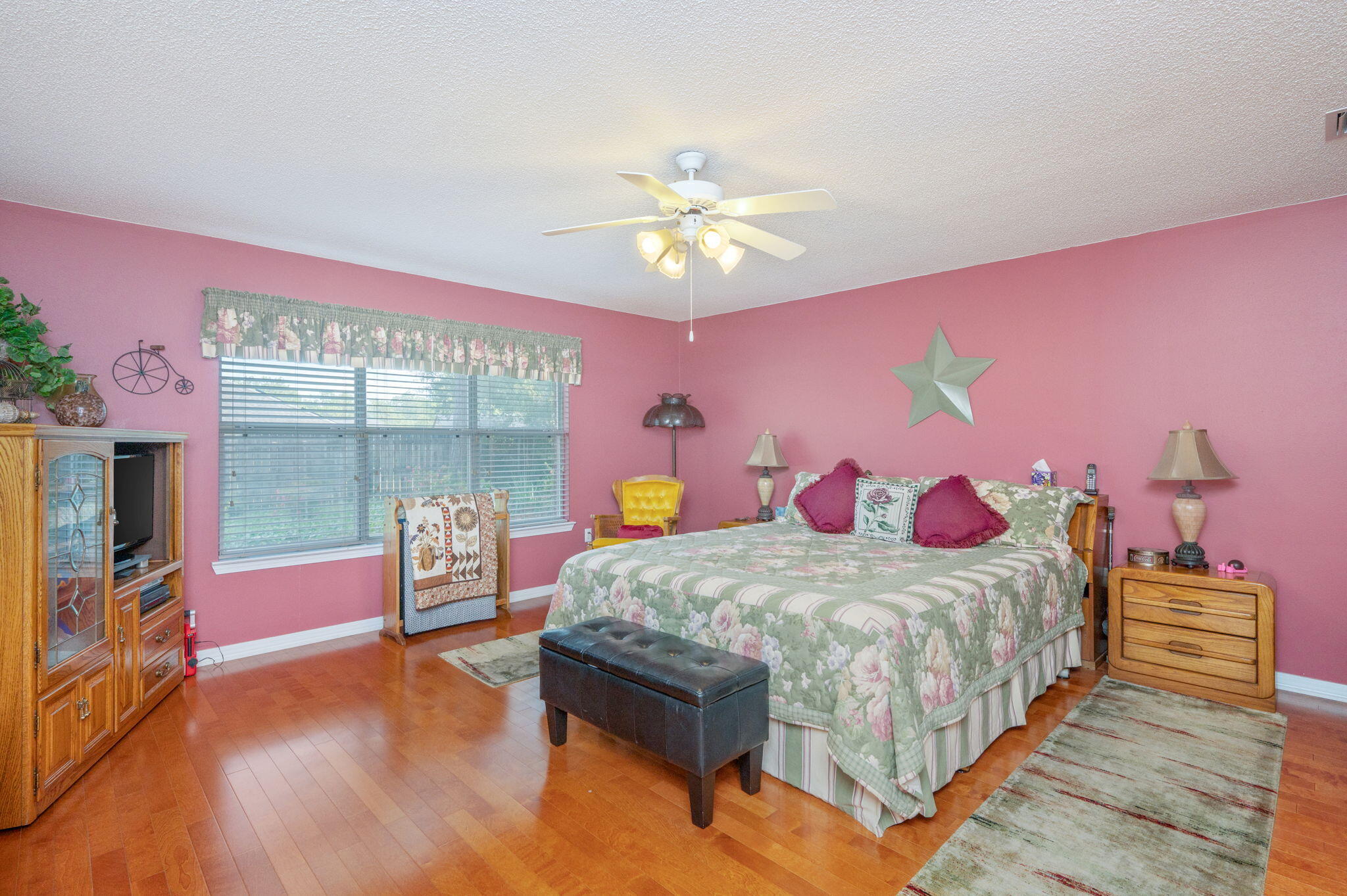 5863 Hunting Meadows Drive Crestview, FL 32536 - Photo 35 of 49 a bedroom with a bed and a chandelier