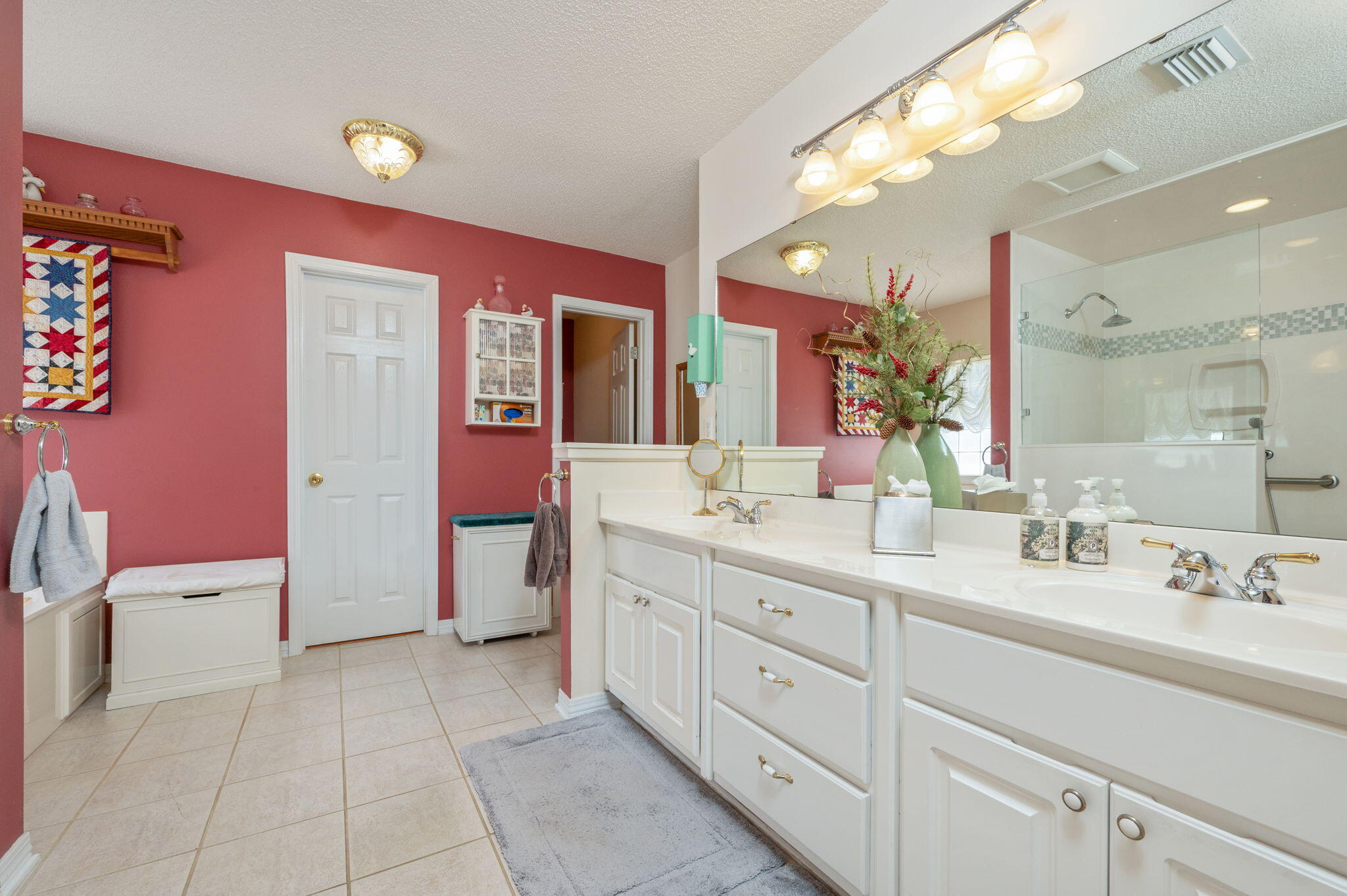 5863 Hunting Meadows Drive Crestview, FL 32536 - Photo 38 of 49 a spacious bathroom with a double vanity sink a mirror and a bathtub