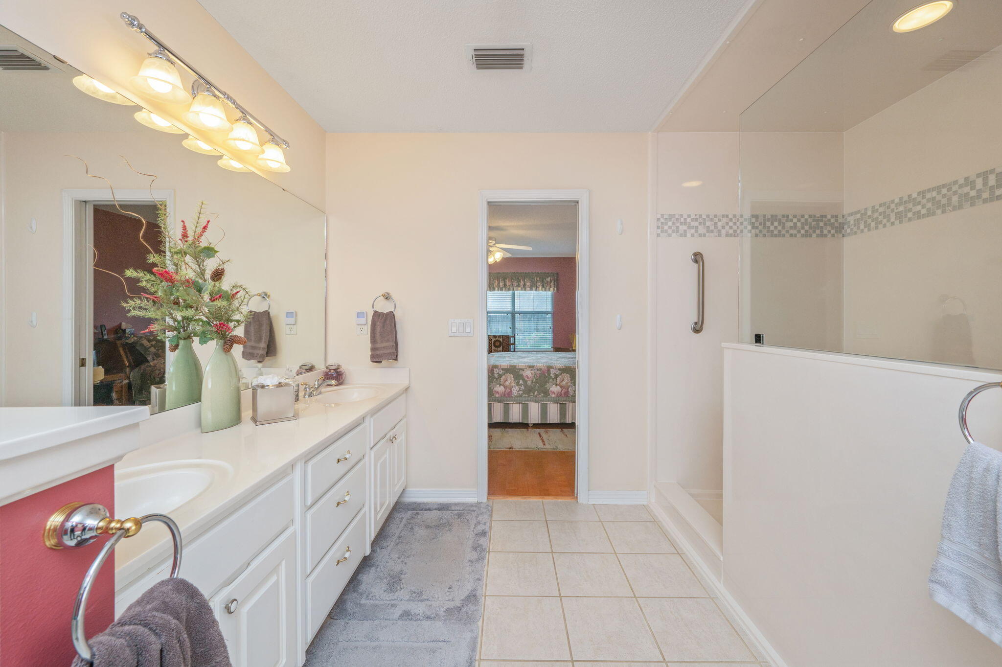 5863 Hunting Meadows Drive Crestview, FL 32536 - Photo 41 of 49 a spacious bathroom with a double vanity sink and a mirror