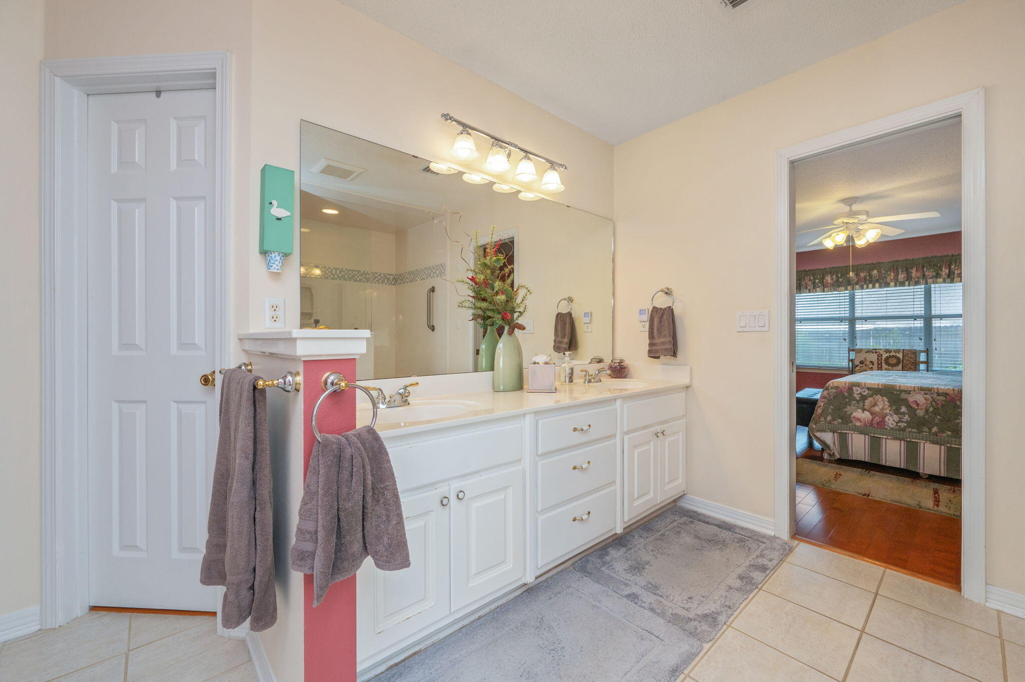5863 Hunting Meadows Drive Crestview, FL 32536 - Photo 42 of 49 a spacious bathroom with a double vanity sink and a mirror