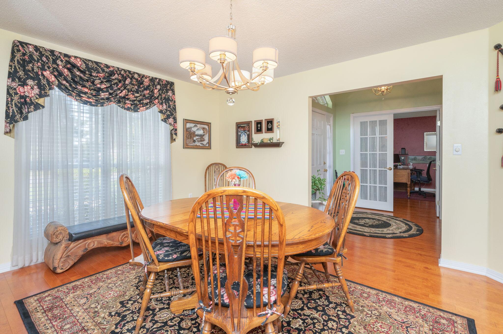 5863 Hunting Meadows Drive Crestview, FL 32536 - Photo 8 of 49 a view of a dining room with furniture and chandelier
