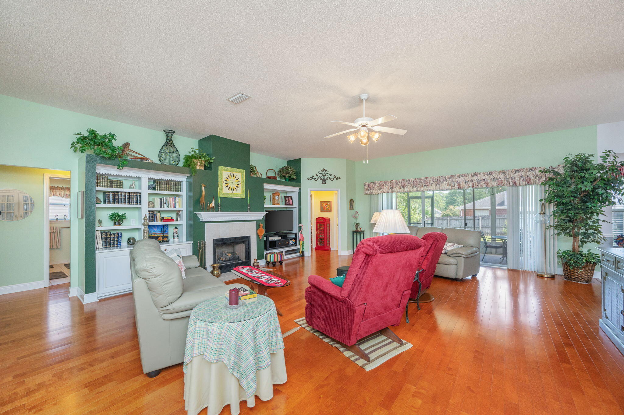 5863 Hunting Meadows Drive Crestview, FL 32536 - Photo 10 of 49 a living room with furniture fireplace and wooden floor