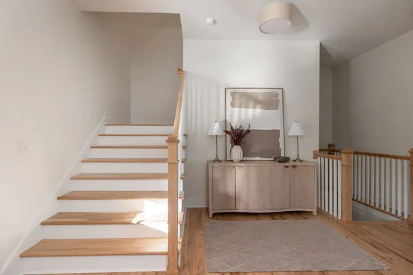 a bathroom with a tub shower and window
